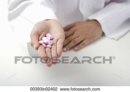 Hand of doctor holding pills View Large Photo Image Stock Image - Hand of doctor holding pills. Fotosearch