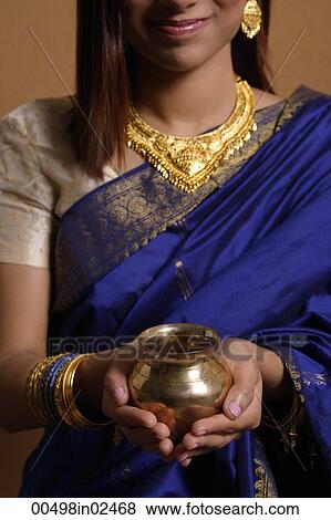 Indian woman holding offering View Large Photo Image Stock Photo - Indian woman holding offering. Fotosearch