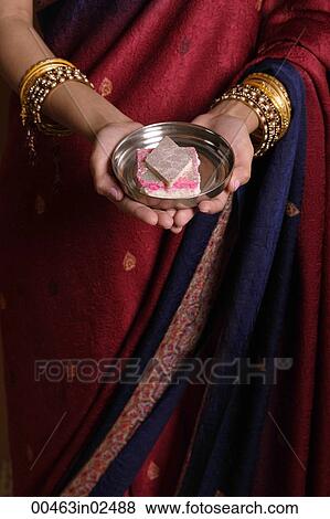 Indian woman offering sweets View Large Photo Image Stock Photo - Indian woman offering sweets. Fotosearch