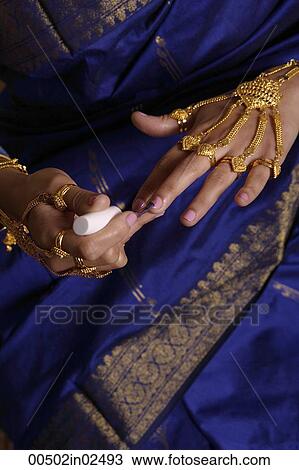 Indian woman painting finger nails View Large Photo Image Stock Image - Indian woman painting finger nails. Fotosearch