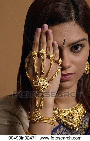 Indian woman wearing traditional wedding jewelry View Large Photo Image Stock Image - Indian woman wearing traditional wedding jewelry. Fotosearch