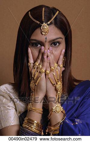 Indian woman wearing traditional wedding jewelry View Large Photo Image Stock Photo - Indian woman wearing traditional wedding jewelry. Fotosearch