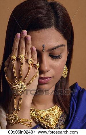 Indian woman wearing traditional wedding jewelry View Large Photo Image Stock Photo - Indian woman wearing traditional wedding jewelry. Fotosearch