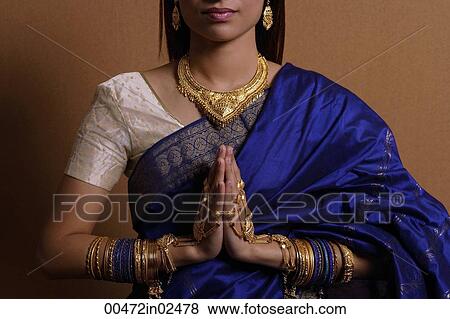Stock Photo - Indian woman with hands held in prayer position. Fotosearch