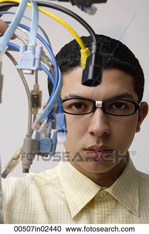 Stock Image - nerd holding up computer cords. Fotosearch