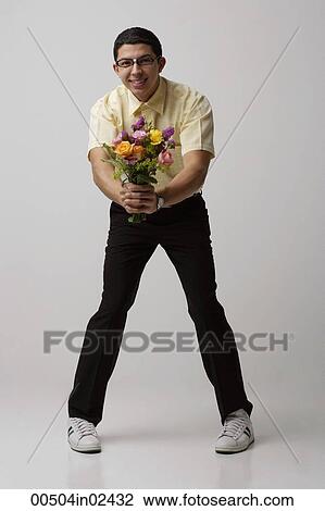 Stock Image - Nerd offering flowers. Fotosearch