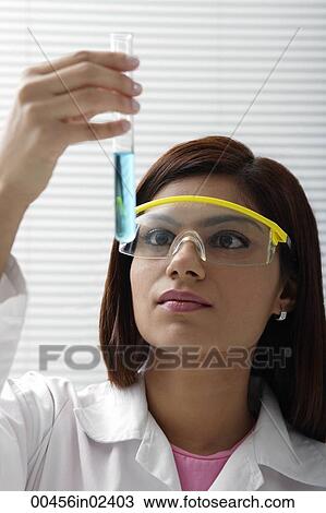 Scientist with vile of liquid View Large Photo Image Stock Image - Scientist with vile of liquid. Fotosearch