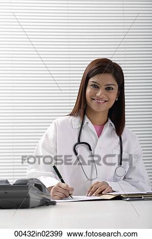 Smiling doctor working with report View Large Photo Image Stock Photo - Smiling doctor working with report. Fotosearch