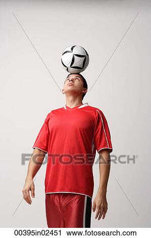 Soccer player with ball on head View Large Photo Image Stock Image - Soccer player with ball on head. Fotosearch