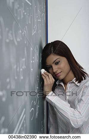 Teacher leaning against chalk board thinking View Large Photo Image Stock Image - Teacher leaning against chalk board thinking. Fotosearch