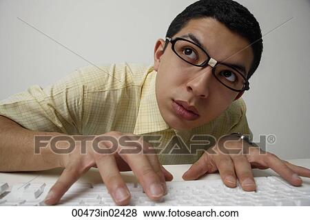 Stock Photo - Tech nerd at keyboard. Fotosearch