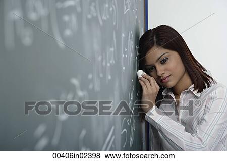 Woman leaning head against chalk board View Large Photo Image Stock Photo - Woman leaning head against chalk board. Fotosearch