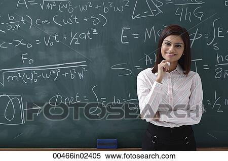 Stock Photography - Woman standing proudly in front of chalk board. Fotosearch