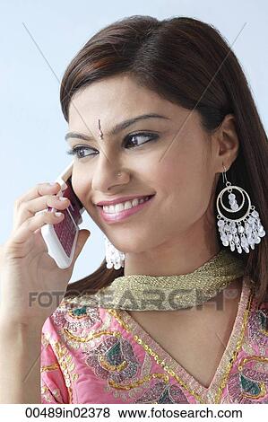 Stock Photo - Young Indian woman on mobile phone. Fotosearch