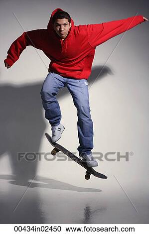 young man wearing red hooded sweatshirt on skateboard View Large Photo Image Stock Image - young man wearing red hooded sweatshirt on skateboard. Fotosearch