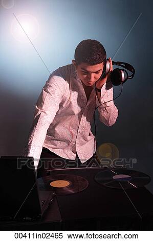 Stock Photography - Young man working as DJ. Fotosearch