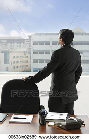 Stock Photo - business man looking out of the window. Fotosearch