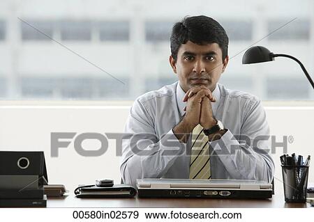 business man resting chin in folded hands View Large Photo Image Stock Photo - business man resting chin in folded hands. Fotosearch
