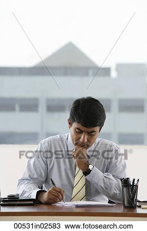 business man writing at his work desk View Large Photo Image Stock Image - business man writing at his work desk. Fotosearch