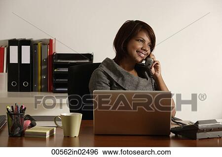 business woman talking on the phone at office desk View Large Photo Image Stock Photograph - business woman talking on the phone at office desk. Fotosearch