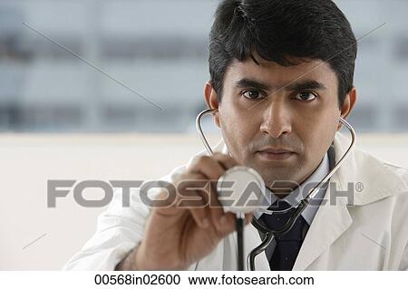 Stock Image - doctor holding up stethoscope. Fotosearch