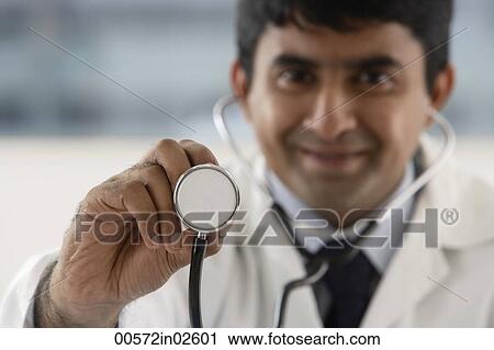 Stock Image - doctor holding up stethoscope. Fotosearch