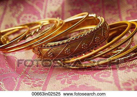 gold Indian bangles on pink sari cloth View Large Photo Image Stock Photography - gold Indian bangles on pink sari cloth. Fotosearch