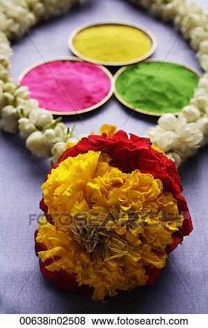 Indian colored powder paints with flower garland View Large Photo Image Stock Photo - Indian colored powder paints with flower garland. Fotosearch