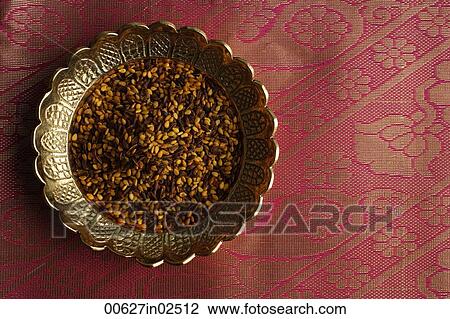Indian digestive mukhwa seeds on brass dish on pink sari cloth View Large Photo Image Stock Image - Indian digestive mukhwa seeds on brass dish on pink sari cloth. Fotosearch