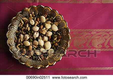 Mix of Indian beans, seeds and nuts in brass dish on pink sari cloth View Large Photo Image Stock Image - Mix of Indian beans, seeds and nuts in brass dish on pink sari cloth. Fotosearch