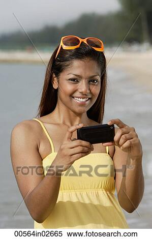 Stock Photography - Portrait of woman with mobile phone camera. Fotosearch