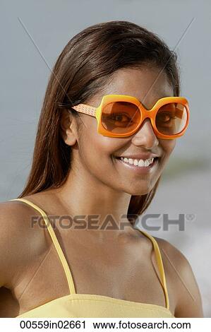 Portrait of woman with sunglasses, smiling View Large Photo Image Stock Image - Portrait of woman with sunglasses, smiling. Fotosearch