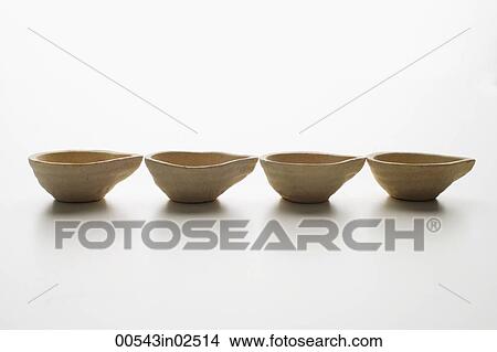 row of clay oil lamps View Large Photo Image Picture - row of clay oil lamps. Fotosearch