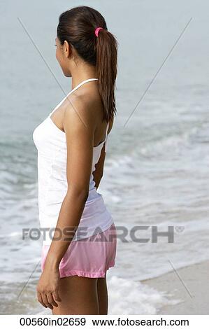 Side view of woman looking at ocean View Large Photo Image Stock Photo - Side view of woman looking at ocean. Fotosearch