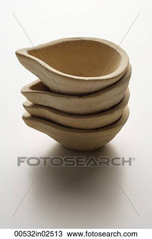 stack of small clay oil lamps View Large Photo Image Stock Image - stack of small clay oil lamps. Fotosearch