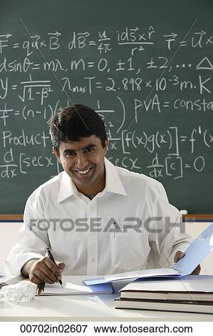 Stock Photo - teacher sitting at desk. Fotosearch