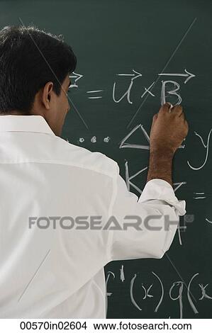 teacher writing formulas on chalkboard View Large Photo Image Picture - teacher writing formulas on chalkboard. Fotosearch