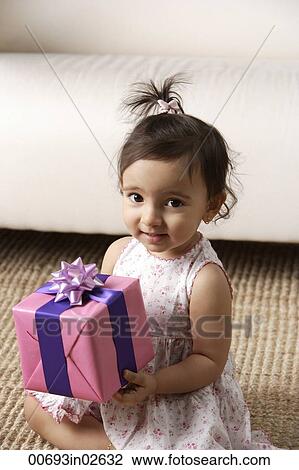 toddler holding a present View Large Photo Image Stock Image - toddler holding a present. Fotosearch