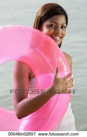 woman at beach with pink tube View Large Photo Image Stock Photo - woman at beach with pink tube. Fotosearch
