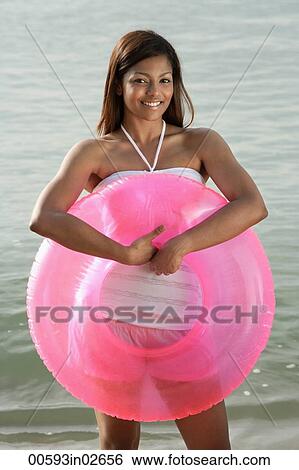 woman at beach with pink tube View Large Photo Image Stock Photograph - woman at beach with pink tube. Fotosearch