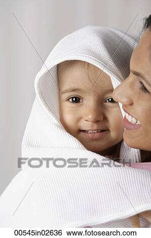 woman carrying baby wrapped in a white towel View Large Photo Image Stock Photograph - woman carrying baby wrapped in a white towel. Fotosearch