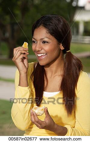 woman eating orange outside View Large Photo Image Stock Photo - woman eating orange outside. Fotosearch