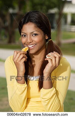 woman eating orange outside View Large Photo Image Stock Photo - woman eating orange outside. Fotosearch