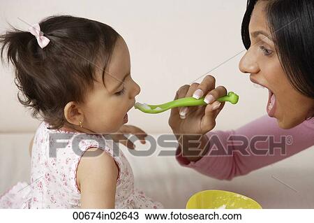 woman feeding baby View Large Photo Image Stock Image - woman feeding baby. Fotosearch