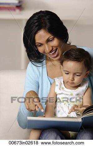 woman flipping picture book with baby View Large Photo Image Stock Photo - woman flipping picture book with baby. Fotosearch