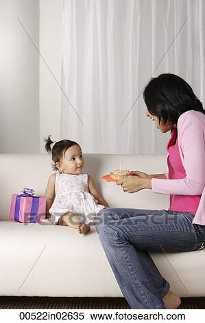 Stock Photography - woman giving food to baby. Fotosearch