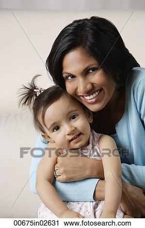 Stock Image - woman hugging her baby. Fotosearch