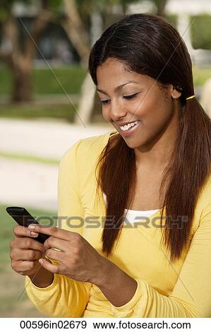 woman looking at phone, smiling View Large Photo Image Stock Photo - woman looking at phone, smiling. Fotosearch