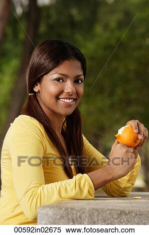 woman peeling orange outside View Large Photo Image Stock Photography - woman peeling orange outside. Fotosearch