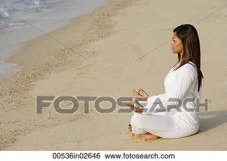 woman practicing yoga at the beach View Large Photo Image Stock Photograph - woman practicing yoga at the beach. Fotosearch